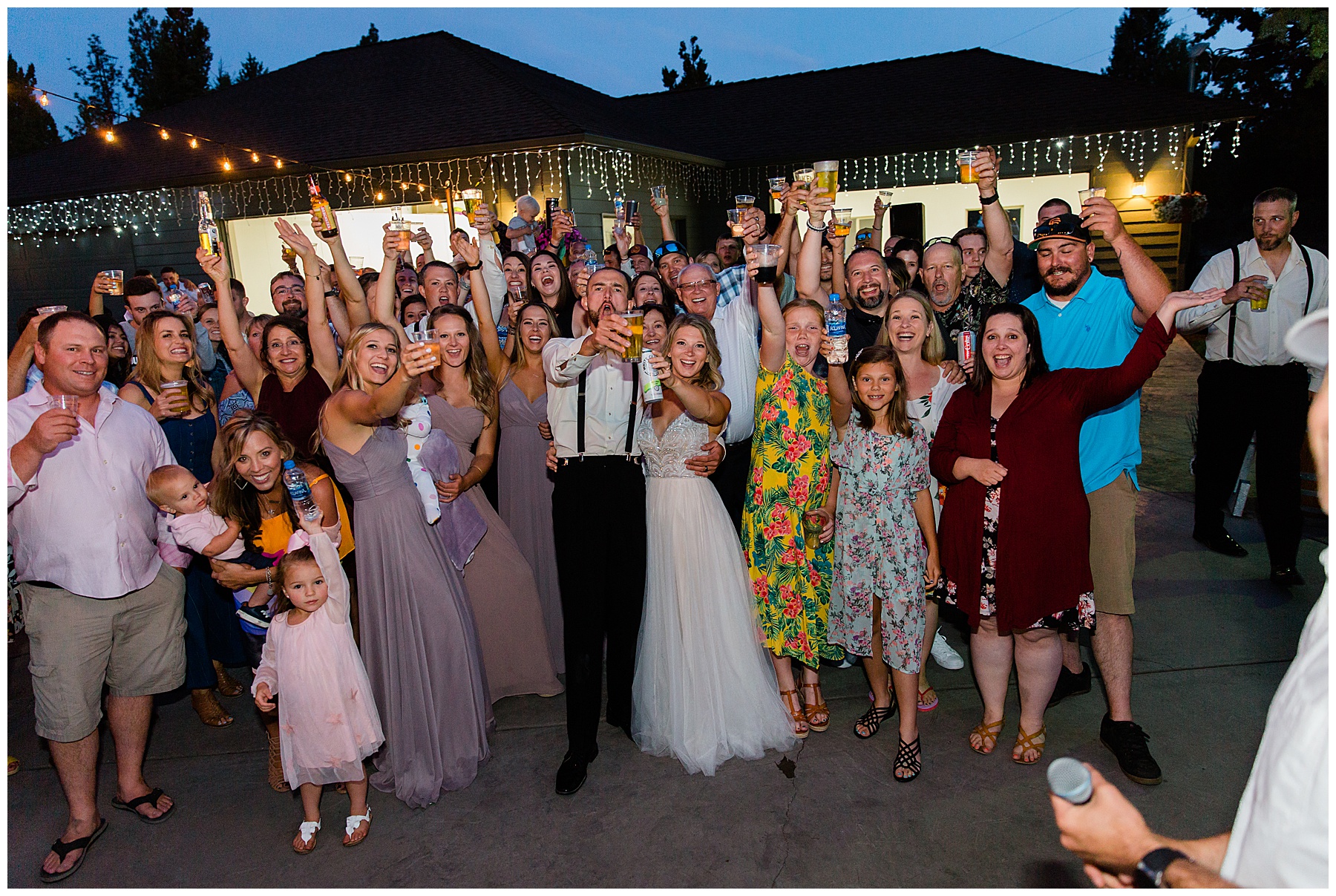 Everyone who attended the Bend Oregon Intimate Backyard Wedding raising their glasses in celebration. 