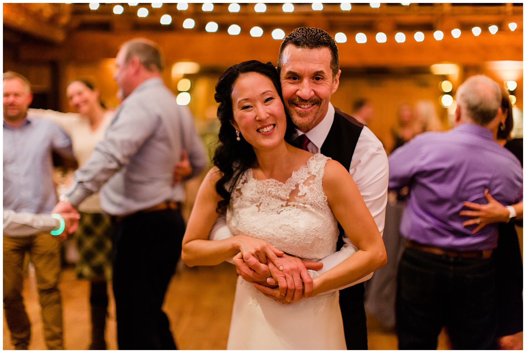 The couple hugs eachother with big smiles for the camera at their Sunriver Resort Fall Riverfront Wedding