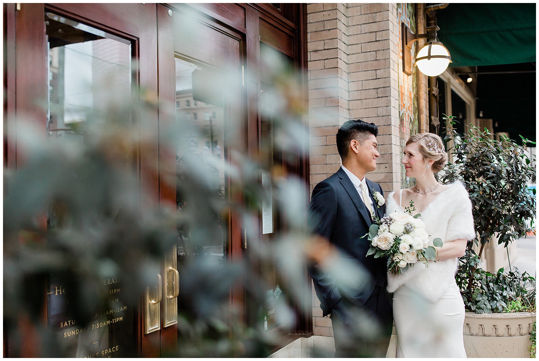 romantic wedding portraits outside the Sentinel hotel in downtown portland oregon. the couple is wearing vintage silk attire.