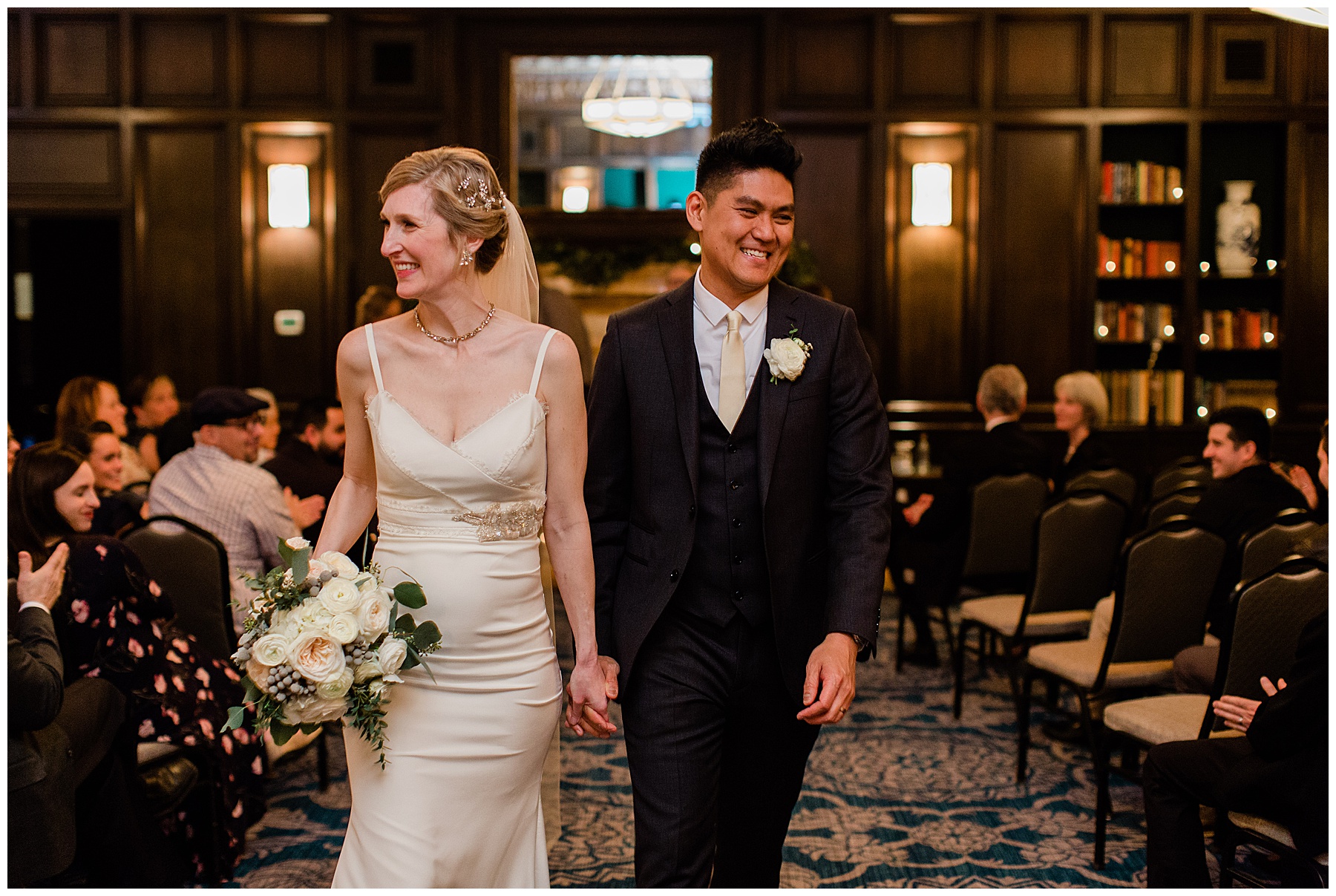 bride and groom walking back down the aisle smiling after their vintage sentinel hotel wedding in downtown portland oregon